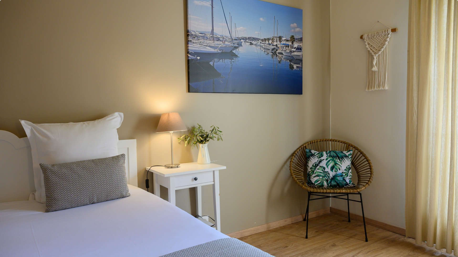 Chambre avec une chaise en osier et un coussin vert - hotel restaurant les baux de provence - Belesso